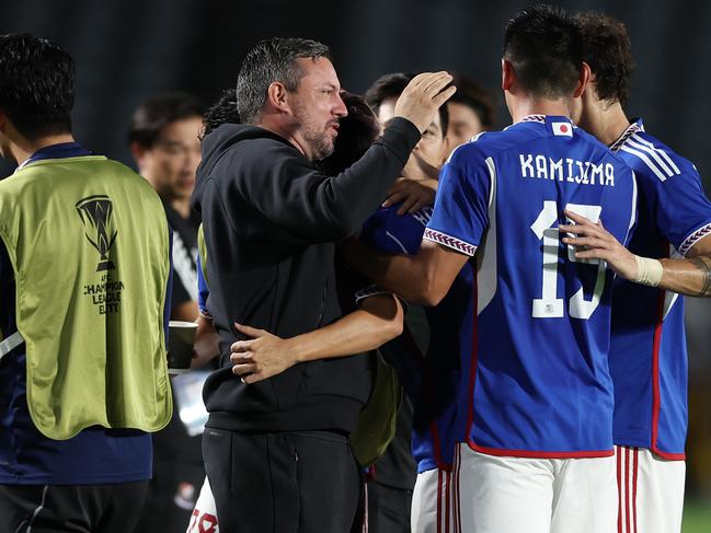 Yokohama F. Marinos coach John Hutchinson (centre) celebrates with his players in Gosford. Picture: Matt King/Getty Images