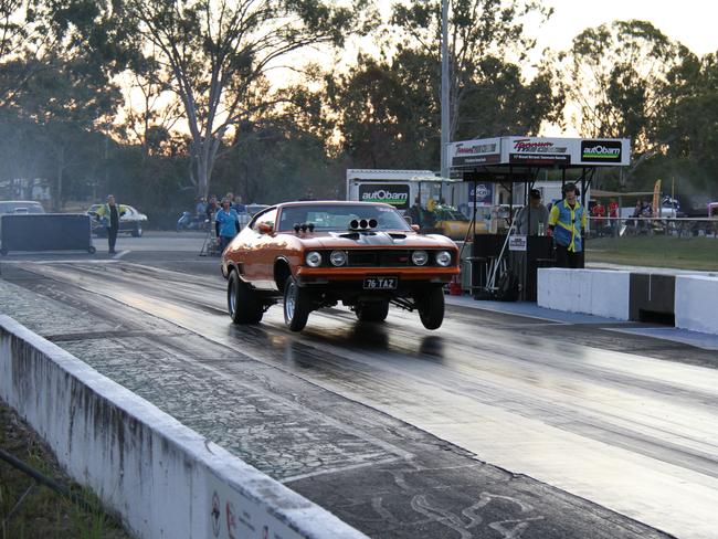 Gladstone's Brett Kelly gets the front wheels off the ground in his Ford Falcon coupe on the way to a low 10 second pass at Benaraby Dragway. Picture: Rodney Stevens