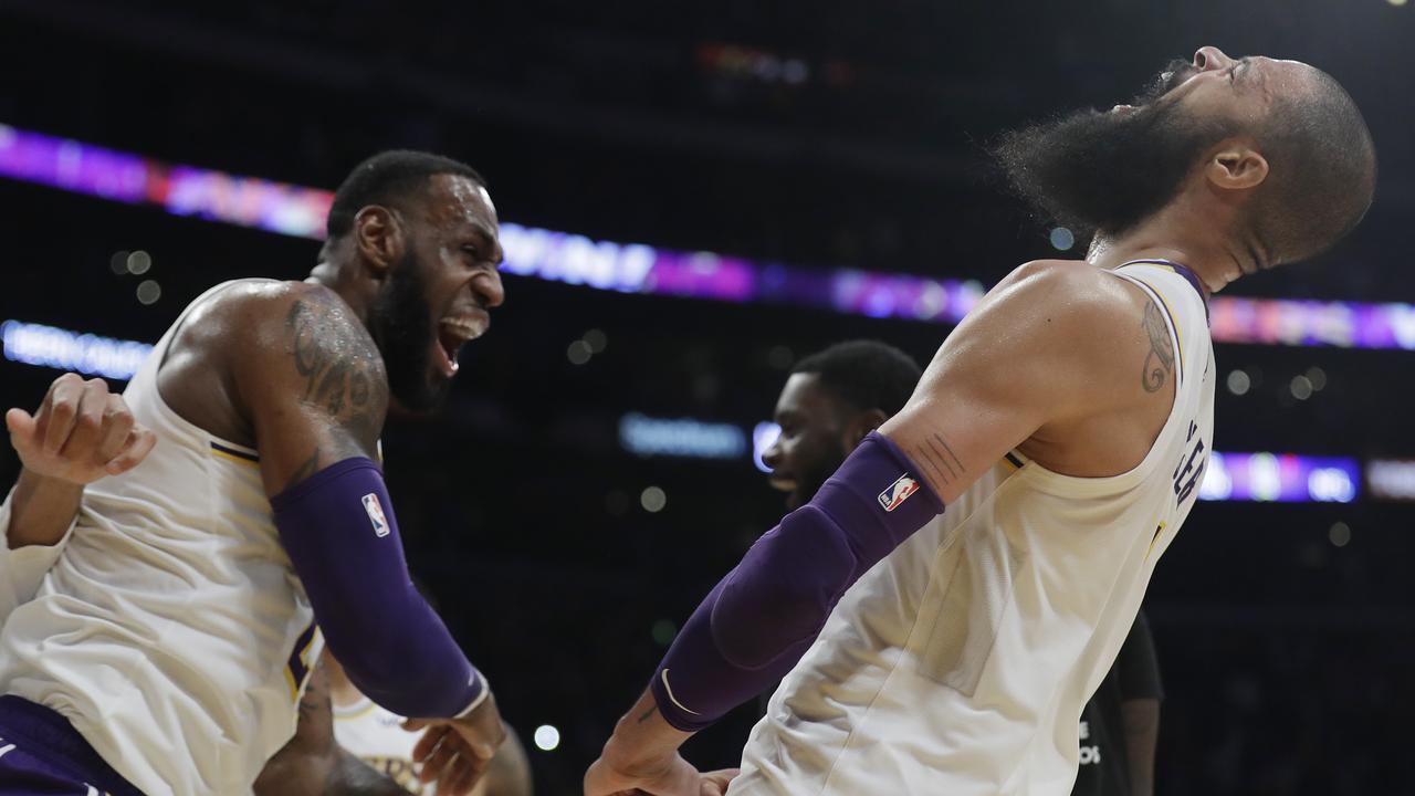 Los Angeles Lakers' Tyson Chandler, right, celebrates with teammate LeBron James after Chandler blocked a shot from Atlanta Hawks' Trae Young as time expired.