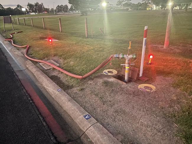 Fireys hooked up a hose to a nearby fire hydrant opposite the Maryvale Hospital. Picture: Jack Colantuono