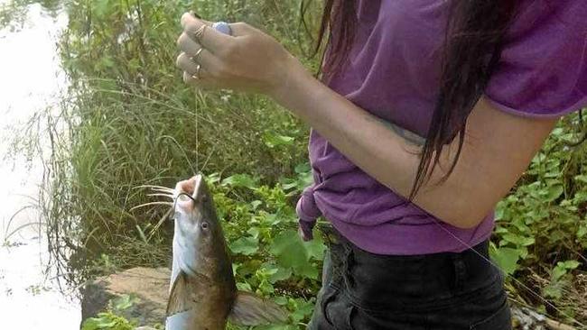 Mary River enthusiast Shannon Striebel pictured with a catch at the river. She was left disgusted this week when she discovered a huge pile of rubbish and skinned fish left by the side of the river.