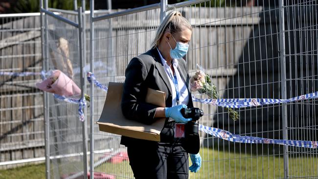 A forensic police officer gathering evidence at the scene. Picture: David Geraghty