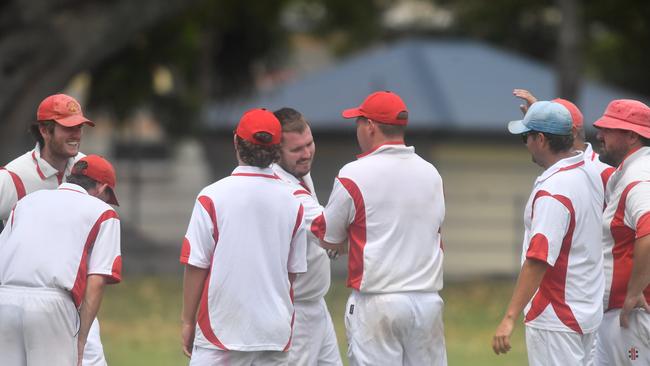 Chris Cleaver is congratulated by his Souths Services teammates for a wicket against Brothers at McKittrick Park