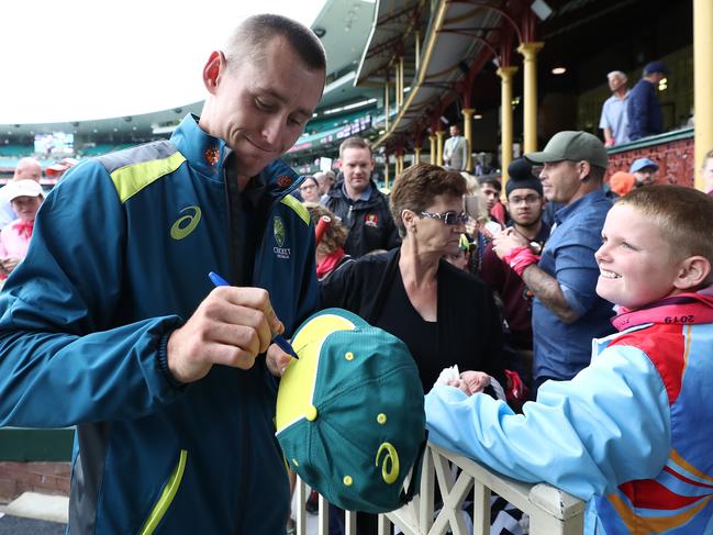 Marnus Labuschagne makes a young boy’s day as he signs autographs during one of the rain delays during the Sydney Test.