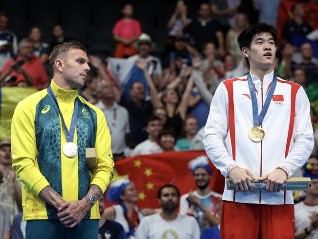 NANTERRE, FRANCE - JULY 31: Silver Medalist Kyle Chalmers of Team Australia and Gold Medalist Zhanle Pan of Team People's Republic of China stand on the podium during the Swimming medal ceremony after the Men's 100m Freestyle Final on day five of the Olympic Games Paris 2024 at Paris La Defense Arena on July 31, 2024 in Nanterre, France. (Photo by Quinn Rooney/Getty Images)