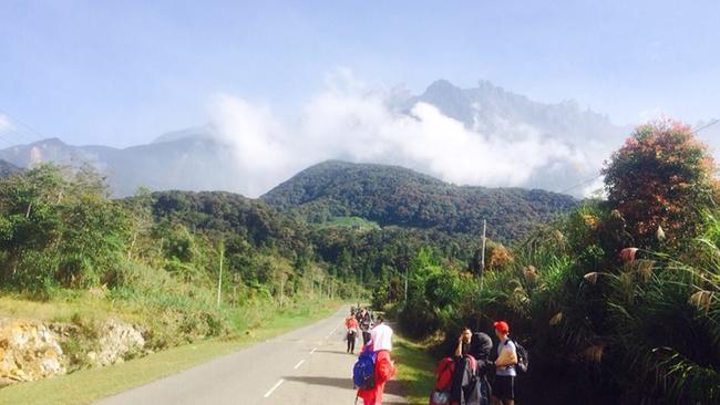 Tourists walk away from Mount Kinabalu hours after a magnitude 5.9 earthquake shook the area in Kundasang, Sabah, Malaysia. Picture: AP