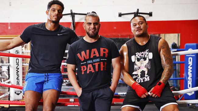 Trainer Hassan El-Achrafi (centre) with NRL players Jason Saab and Joey Leilua before training for professional boxing matches at Final Round Gym in Prestons. Picture: Sam Ruttyn