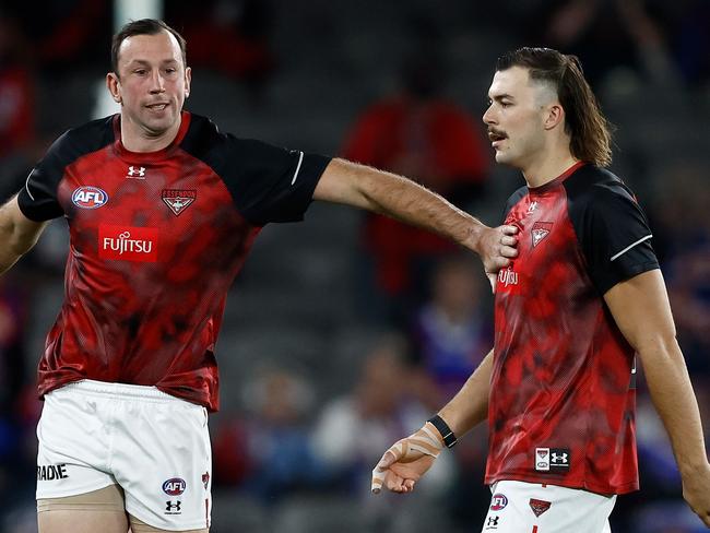 MELBOURNE, AUSTRALIA - APRIL 12: Todd Goldstein (left) and Sam Draper of the Bombers warm up during the 2024 AFL Round 05 match between the Western Bulldogs and the Essendon Bombers at Marvel Stadium on April 12, 2024 in Melbourne, Australia. (Photo by Michael Willson/AFL Photos via Getty Images)