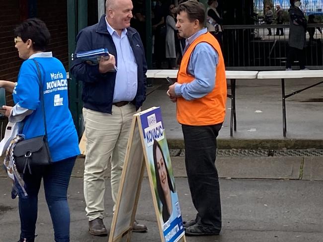 Transport and Veterans Minister David Elliot hands out flyers for Liberal candidate for Parramatta, Maria Kovacic, at Toongabbie Public School. He had some harsh words for Labor’s Andrew Chandler.