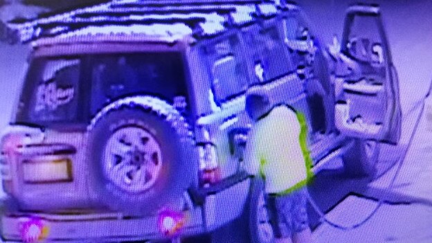 One of the four kids filling up the Nissan Patrol at the service station in Banana.