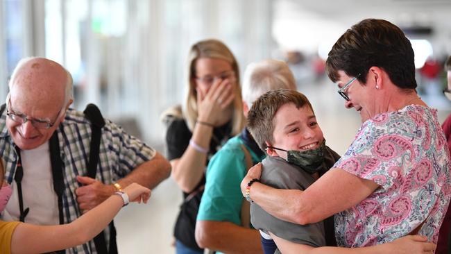 The Weatherill and Dawe families are reunited at Adelaide Airport after a flight from Sydney on Friday. Picture: NCA NewsWire / David Mariuz