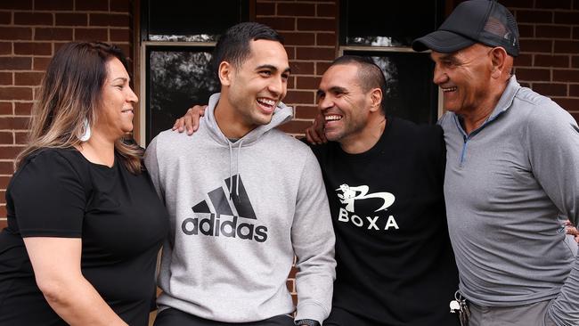 Reimis Smith, with mum Kelly and Anthony and Tony Mundine. (Sam Ruttyn)