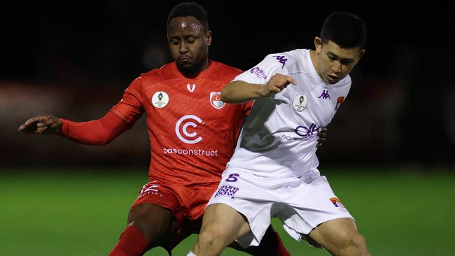 Hume City’s Mark Ochieng challenges Hikaru Ichigi of FC Melbourne.