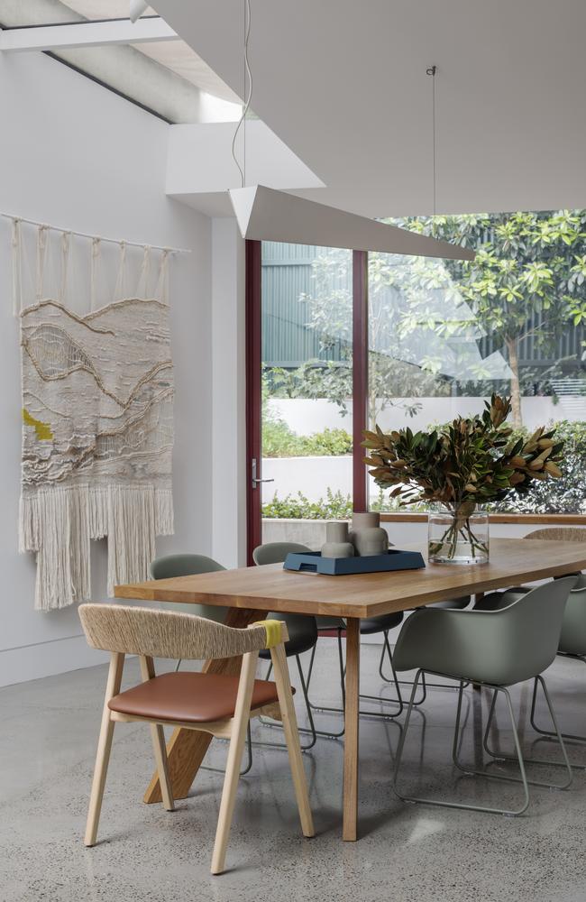 A large wall hanging from Crossing Threads adds warmth in the dining room while the pendant light was repositioned.