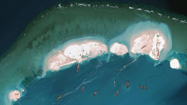 Photos by satellite-imagery provider DigitalGlobe shows what is believed to be Chinese vessels dredging sand in the South China Sea.