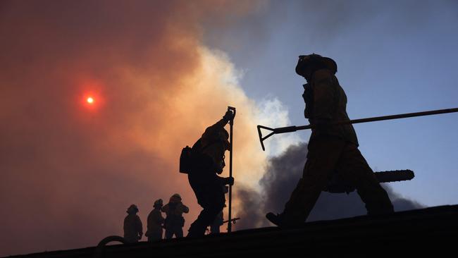 Firefighters work as a brush fire burns in Pacific Palisades, California. Picture: AFP