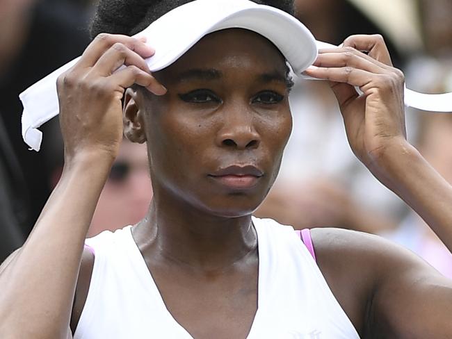 US player Venus Williams adjusts her cap between games against Belgium's Elise Mertens during their women's singles first round match on the first day of the 2017 Wimbledon Championships at The All England Lawn Tennis Club in Wimbledon, southwest London, on July 3, 2017. / AFP PHOTO / Glyn KIRK / RESTRICTED TO EDITORIAL USE