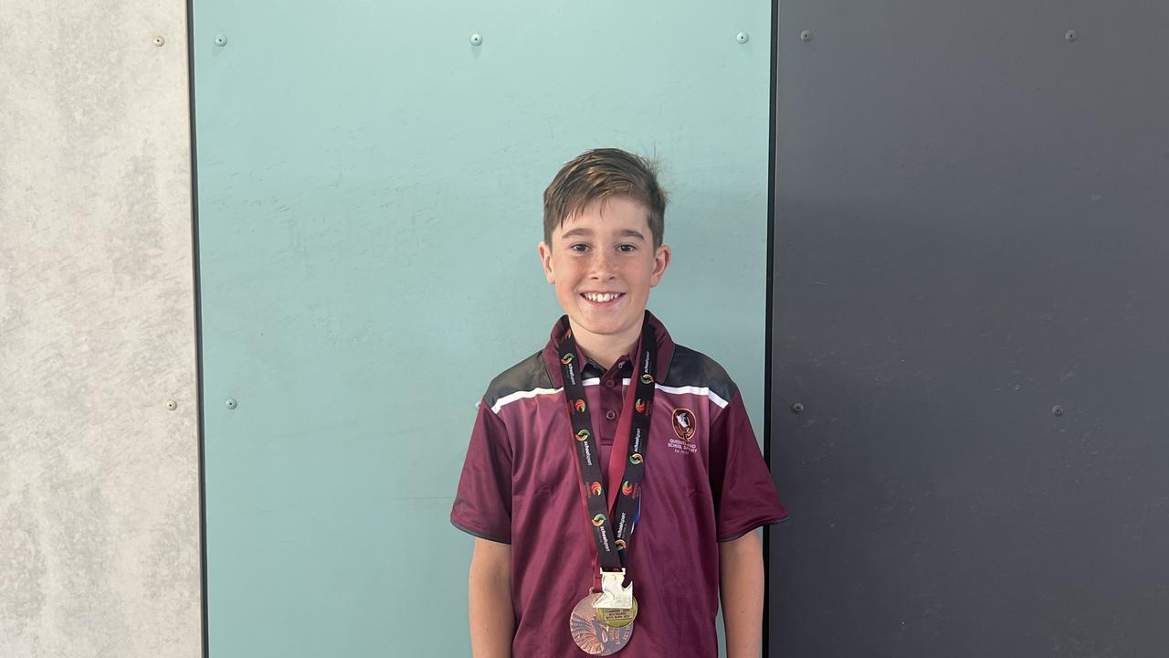 Our Lady of Lourdes student Odin Phillips with his cross country medals.