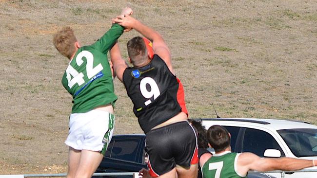 Hoppers player Riley Fisher tries to punch the ball away from a Creswick player. Picture: Suzi Rainsford.