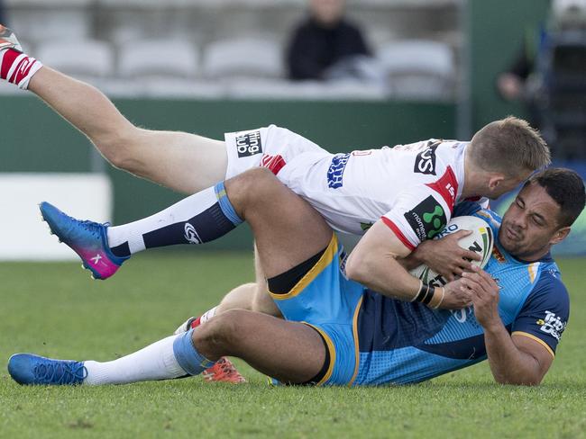 Titans star Jarryd Hayne is tackled by Dragons opponent Matthew Dufty during Gold Coast’s loss to St George Illawarra at UOW Jubilee Oval on Saturday. Picture: AAP