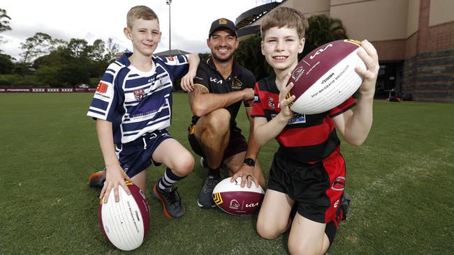 Toby King, 10, and Will Scanlan, 8, with retired Bronco Matt Gillett at Red Hill. Picture: Josh Woning