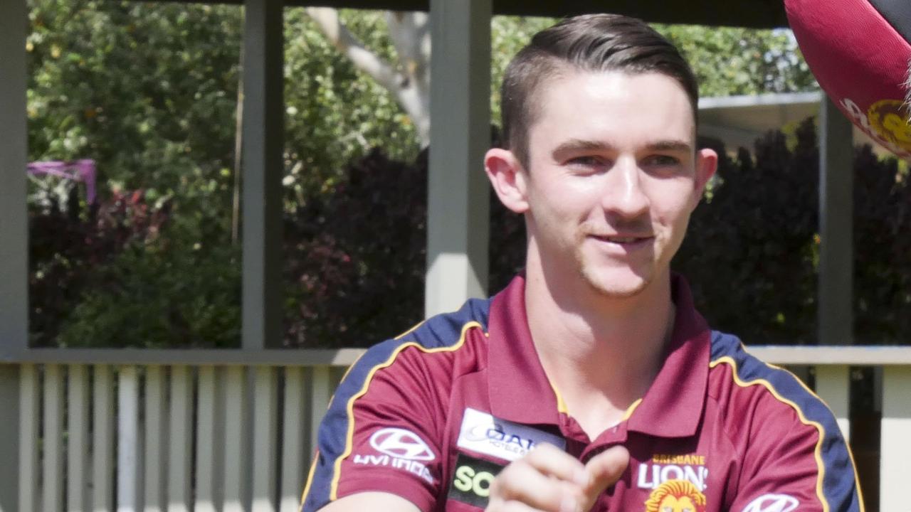 AFL Queensland's Fraser Coast development coordinator Kieron Hyndman with Sunshine Coast and Wide Bay regional manager Paul Tresise practicing their handballs in Torquay ahead of five Brisbane Lions players visiting the region.