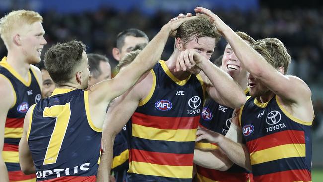 Crows players get around Alex Keath after he was named as the Showdown Medal winner. Picture: SARAH REED