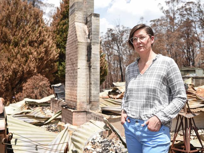 Photo of Sarah Haslinger standing in front of her house which burned down in a bushfire in Sutton Forest Inn, Illawarra On 26.01.2020.(Daily Telegraph / Flavio Brancaleone)