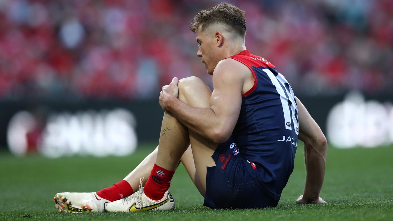 Jake Melksham of the Demons holds his knee. Picture: Jason McCawley/AFL Photos/via Getty Images