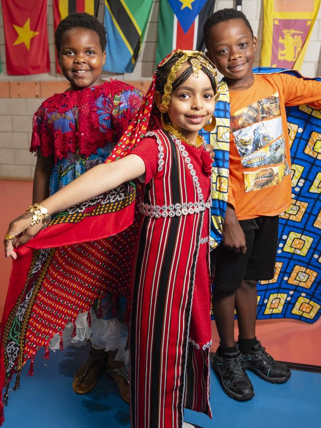 Representing their culture are (from left) Faith Bahati, Chum Ibrahim and Dieume Antoine at Harmony Day celebrations at Darling Heights State School. Picture: Kevin Farmer