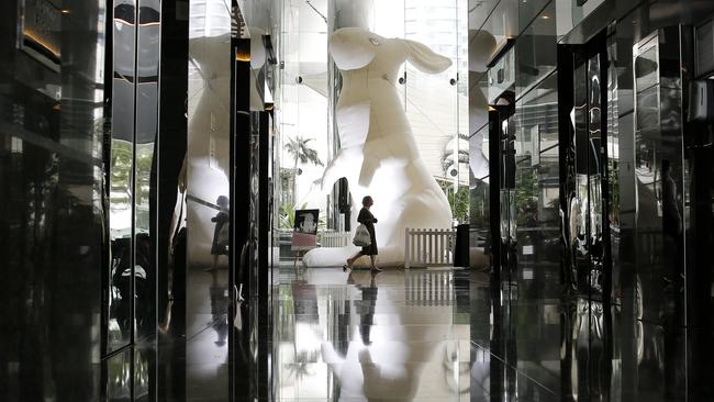 March 2020: Office workers walking past a giant bunny at One Eagle Street as part of the 'Intrude' exhibition from artist Amanda Parer. Picture: AAP Image/Josh Woning