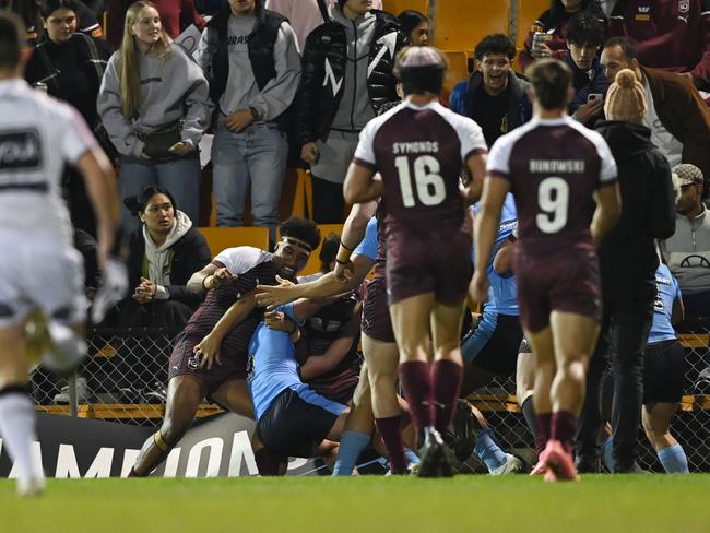 The action spills onto the fence. Picture: NRL Photos/Gregg Porteous