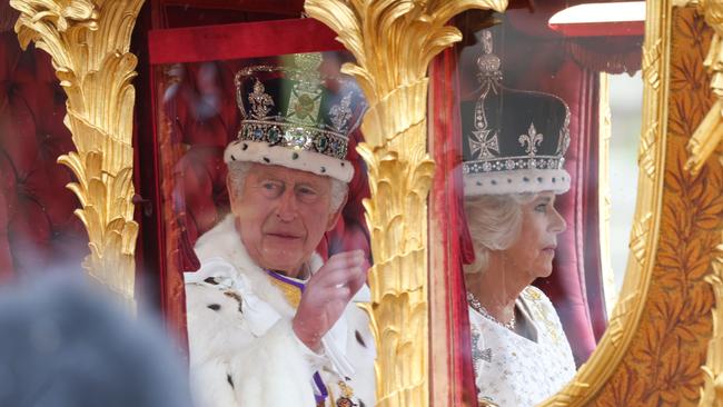 King Charles III and Queen Camilla are pictured leaving Westminster Abbey after the coronation.