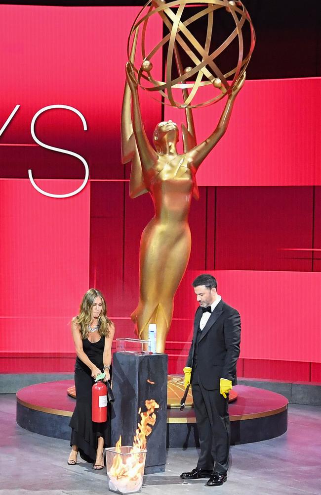 Jennifer Aniston extinguishing flames from a burning ballot at the Staples Center during the 72nd Primetime Emmy Awards. Picture: AFP