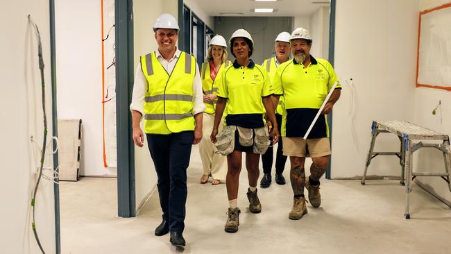 Queensland Premier Steven Miles walks with Health Minister Shannon Fentiman, plasterer Chelsea Drury, Cairns MP Michael Healy and plasterer Paul Obodin as they inspect construction work on the Cairns Hospital emergency department expansion in February. Picture: Brendan Radke