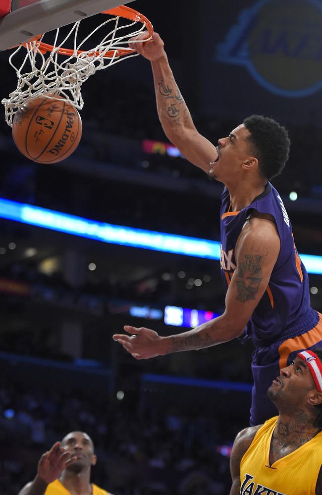 Phoenix Suns guard Gerald Green dunks as Los Angeles Lakers forward Jordan Hill, lower right, watches along with guard Kobe Bryant.