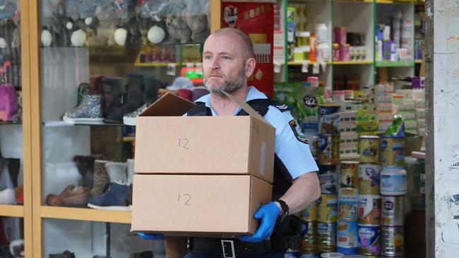 Police raid a store at Bankstown City Plaza. Picture: David Swift