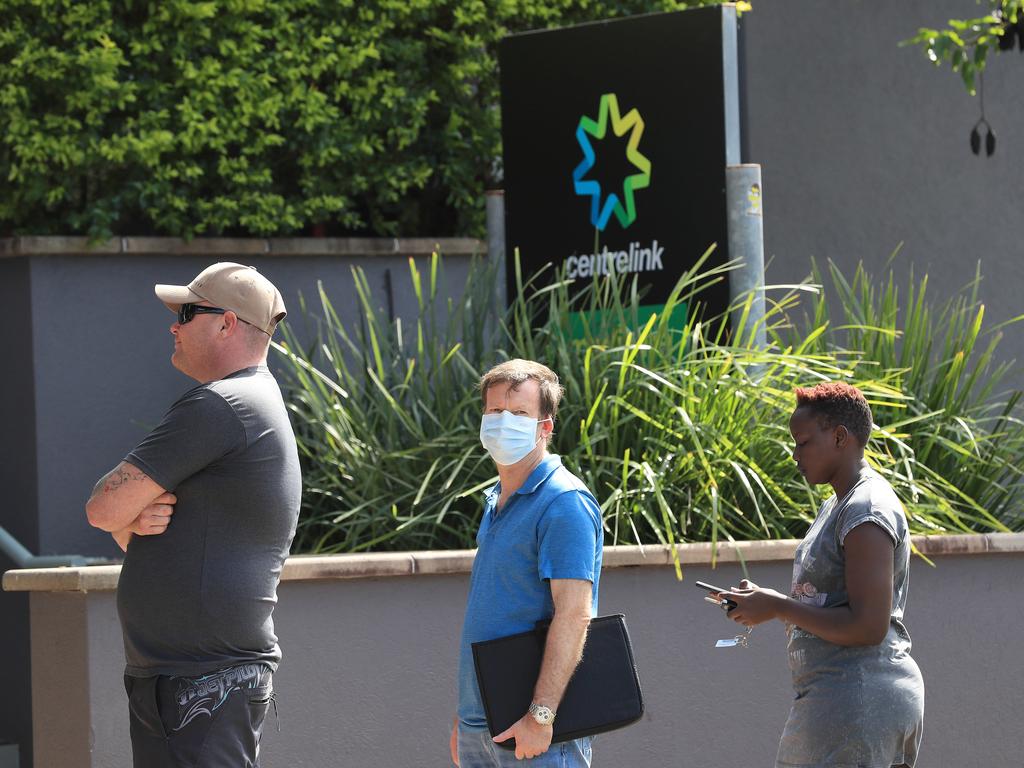 Lines of people wait at Southport Centrelink. Picture: Adam Head.