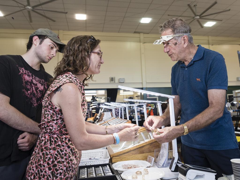 Leo Arday and Nicole Cooper chat to stall holder Brian about imperial topaz at Gemfest hosted by Toowoomba Lapidary Club at Centenary Heights State High School, Saturday, October 21, 2023. Picture: Kevin Farmer