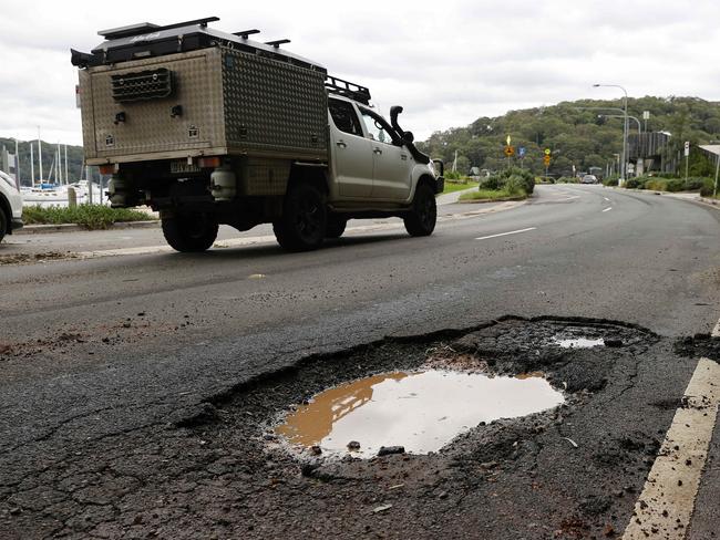 Pothole on Mccarrs Creek Road. One of just thousands across the state. Picture: Tim Hunter.