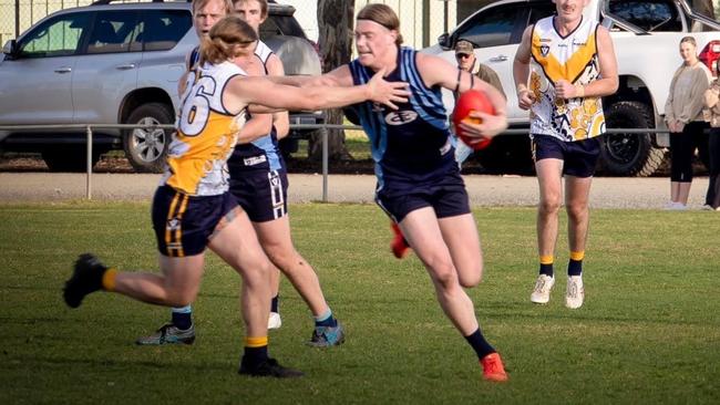 Harley Reid with his traditional fend off during a game for Tongala. Picture: Tracey Hughes Photography.