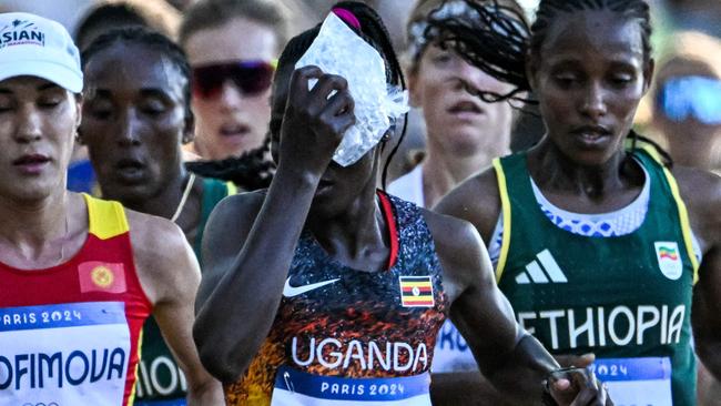 Cheptegei wipes her forehead during the women’s marathon in Paris. Photo by Kirill KUDRYAVTSEV / AFP