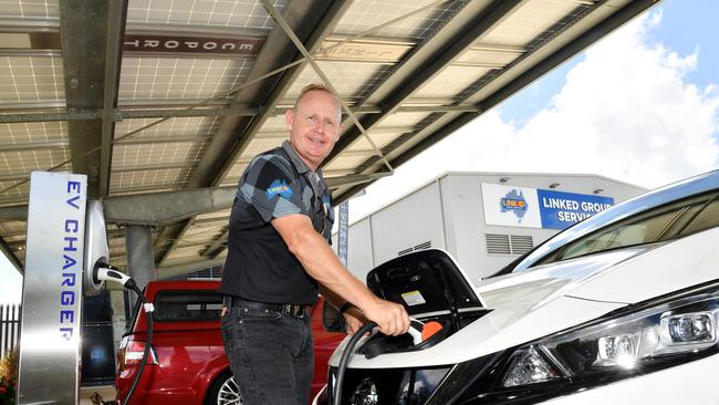 Managing Director of Linked Group Services Jason Sharam and the car charging station. Picture: Tony Martin