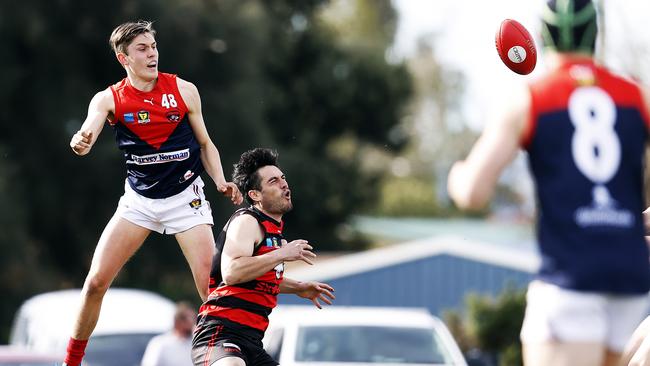 Patrick Walker climbs high to spoil in a Tassie state league game. Picture: Zak Simmonds