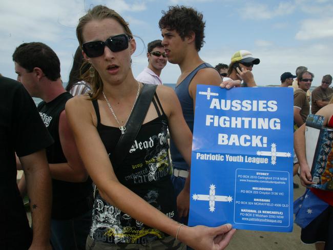 A young woman holds a Patriotic Youth League poster.