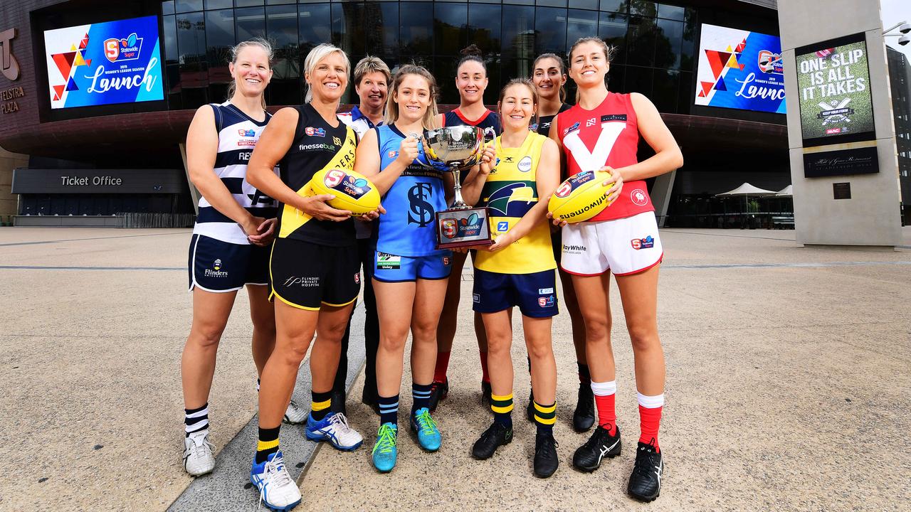 L-R Captains  South Adelaide - Lauren Buchanan ,Glenelg -  Cass Hartley , Centrals Assistant coach Natalie Seaman, Sturt Georgia Bevan, Norwood Leah Cutting,Eagles Adele Gibson, West Adelaide Lauren Rodato and North Adelaide Nadia Von Bertouch pose out the front of Adelaide Oval during the SANFLW launch  today Monday February 11,2019.(Image AAP/Mark Brake)