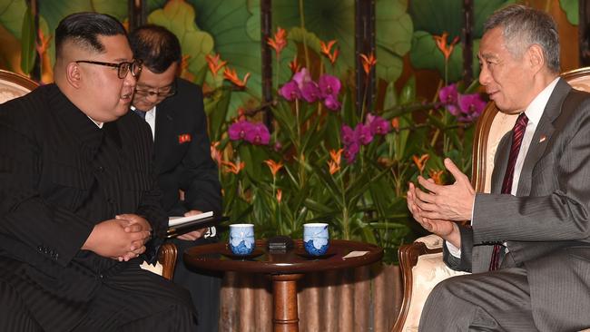 Kim Jong Un (L) listens to Singapore's Prime Minister Lee Hsien Loong (R) during his visit to The Istana, the official residence of the prime minister. Picture: AFP.