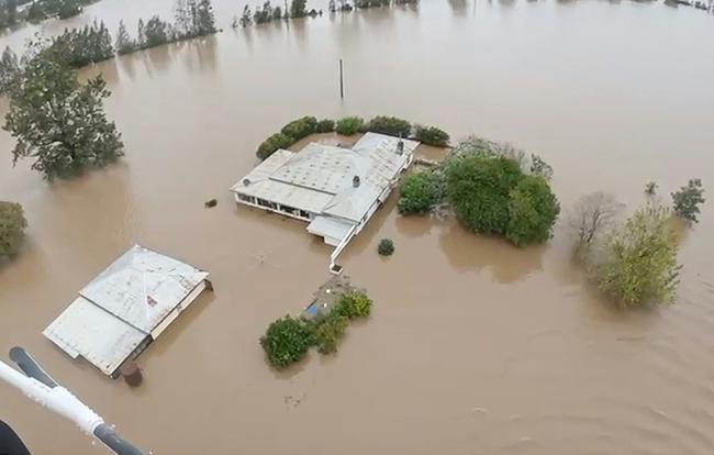 This frame grab from a handout video footage taken between May 21 and 22, 2025 and released on May 22, 2025 by the New South Wales (NSW) Police Force shows a police helicopter rescue in flooded areas near the NSW town of Taree. Rising floodwaters stranded more than 50,000 people in eastern Australia on Thursday, as torrential rain pummelled water-logged towns for a second day and engorged rivers swallowed roads, leaving two dead.