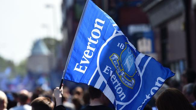 (FILES) Everton supporters wave the club's flag before the start of the English Premier League football match between Everton and Bournemouth at Goodison Park in Liverpool, north west England on May 28, 2023. Everton have been docked 10 points after being found guilty of breaching Premier League financial rules, plunging one of England's most storied football clubs into the relegation zone. The punishment, the biggest sporting sanction in the history of the competition, leaves Sean Dyche's side 19th in the table on a total of just four points after 12 matches -- five points from safety. (Photo by PETER POWELL / AFP) / RESTRICTED TO EDITORIAL USE. No use with unauthorized audio, video, data, fixture lists, club/league logos or 'live' services. Online in-match use limited to 120 images. An additional 40 images may be used in extra time. No video emulation. Social media in-match use limited to 120 images. An additional 40 images may be used in extra time. No use in betting publications, games or single club/league/player publications. /