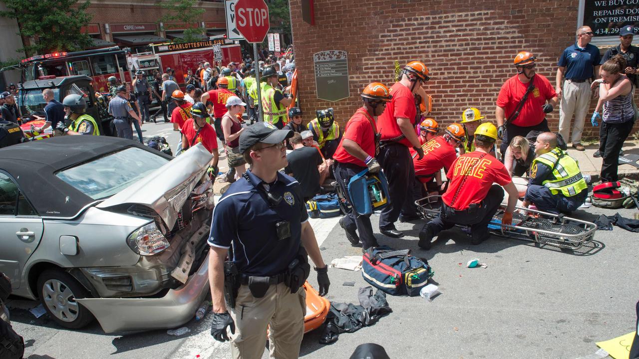 A woman receives first aid after a car rams into protesters. Picture: Paul J Richards/AFP